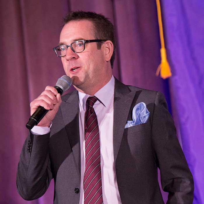Man in suit talking in microphone