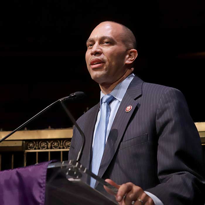 Man in suit giving speech at a podium