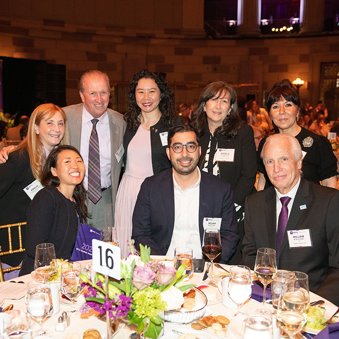 Group photo at a table at the NYU Alumni Awards ceremony
