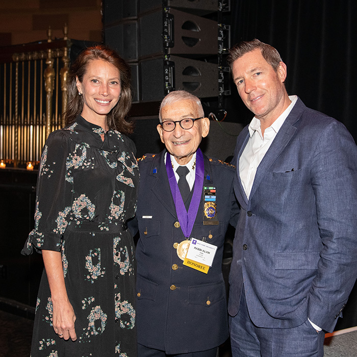 A woman and man posing with an honoree