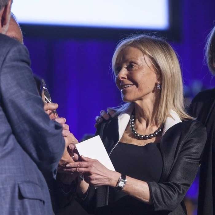 Woman on stage accepting an NYU Alumni Award