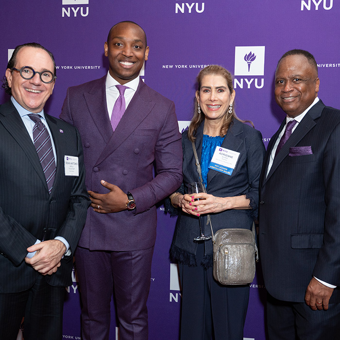 Group of people in front of NYU Alumni Awards banner